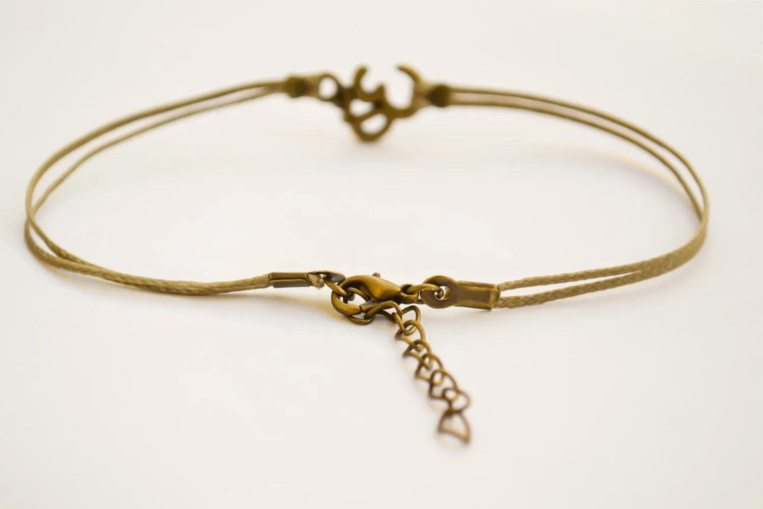 Brown cord anklet with bronze tone Om charm