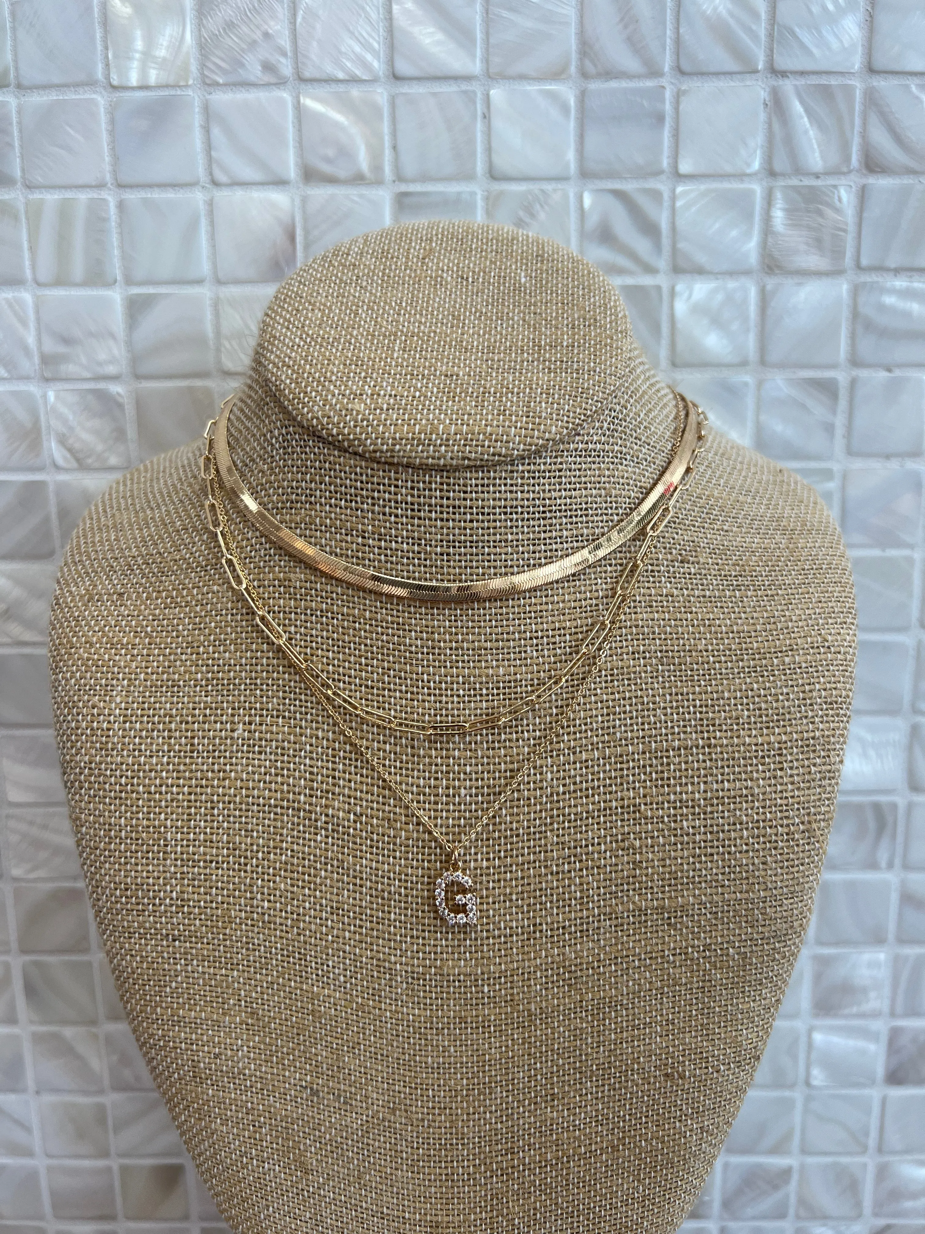 GOLD SNAKE, PAPERCLIP, AND CRYSTAL PENDANT INITIAL LAYERED NECKLACE